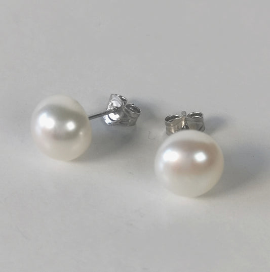 Boucles d'oreilles perles blanches 9mm sur clous argent. Présentées l'une à coté de l'autre , perles en bas. Vue de face.